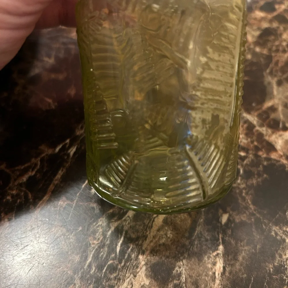 yellow iridescent glass vase with a leaf etching